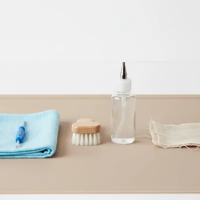 Essential tools for DIY sewing machine cleaning and oiling, including lint brush, oil, and screwdriver